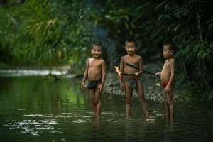 West Sumatra Mentawai Tribe Kids Playing in the River - Photo courtesy of Mohammed Saleh Bin Dollah
